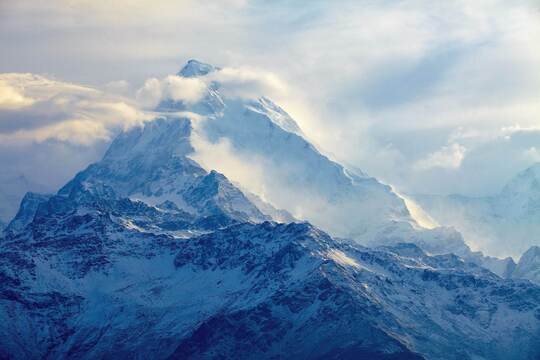 Die Edelmetallprognose für 2021 ein Bild mit blauen Bergen, umgeben von Nebel und Wolken