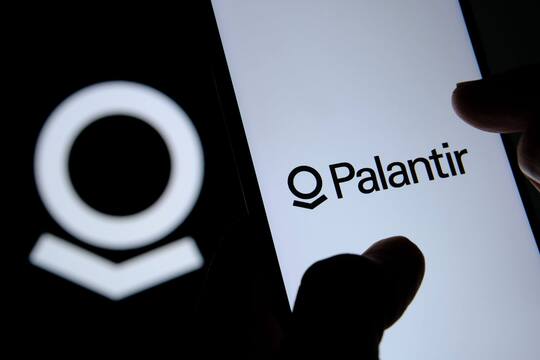 Weekly Digest: Palantir Buys Gold, Bezos vs. Musk us tech giant palantir banner on the phone screen with a black and white palantir logo in the background