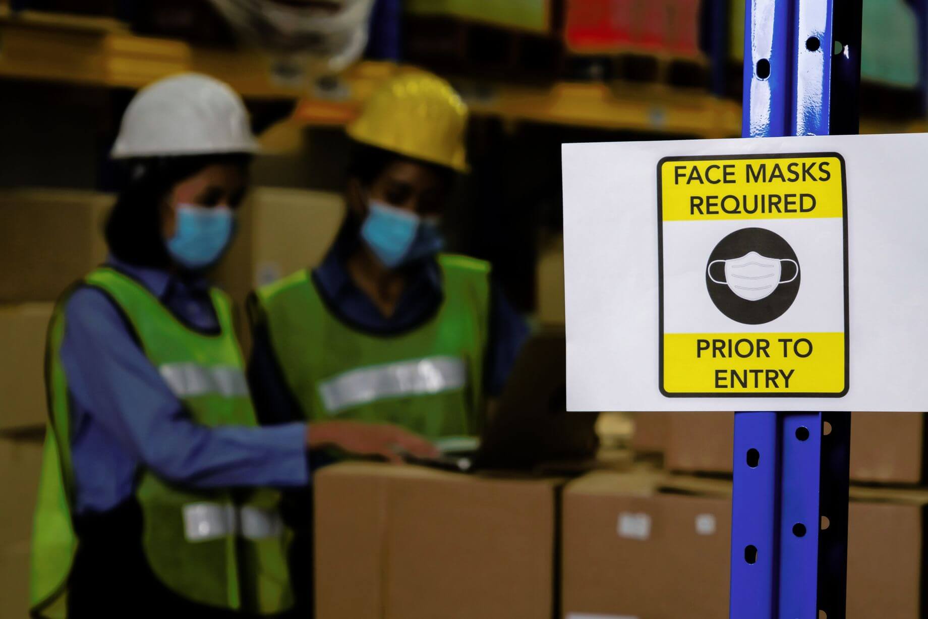 Many countries are still struggling to overcome supply chain crisis caused by Covid-19 lockdowns and these supply shocks are the key cause of high inflation as shown in the picture of two women in masks sorting out boxes with goods.